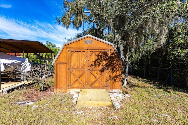 view of outbuilding featuring a carport and a yard