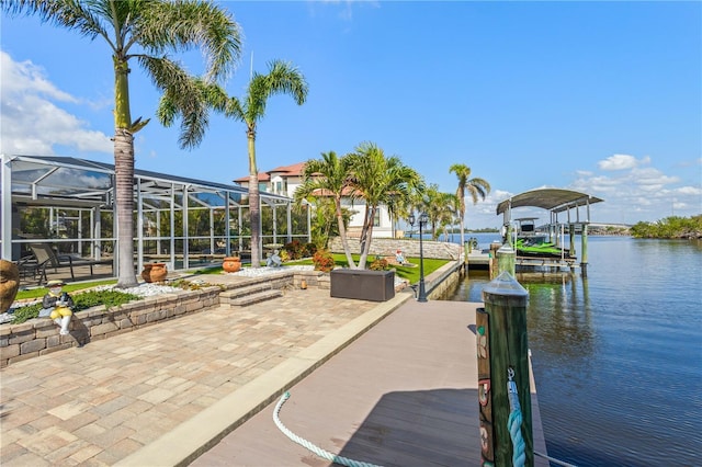 view of dock with a water view and glass enclosure