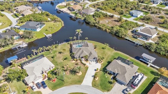 birds eye view of property with a residential view and a water view