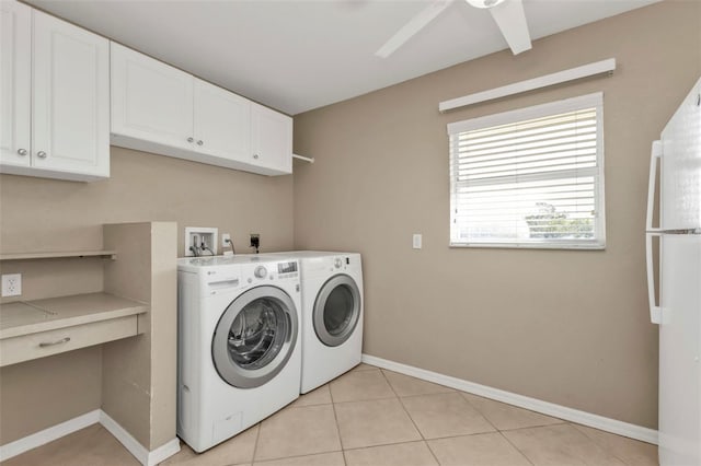 clothes washing area featuring cabinet space, light tile patterned floors, baseboards, ceiling fan, and washing machine and dryer