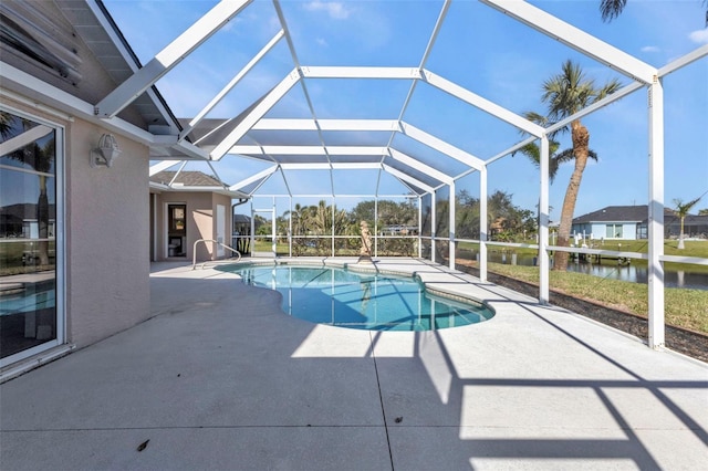 pool with glass enclosure and a patio