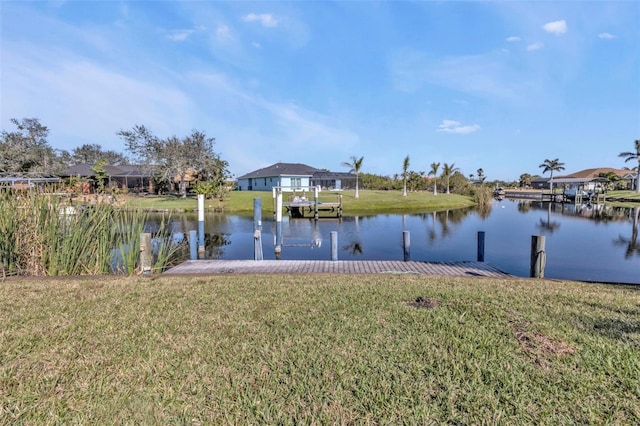 dock area featuring a lawn and a water view