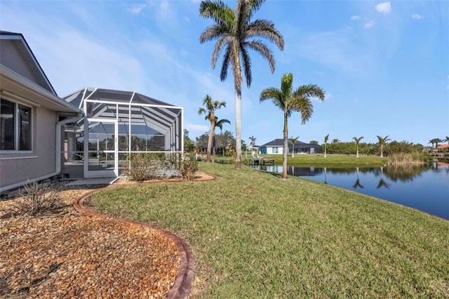 view of yard featuring a water view and glass enclosure