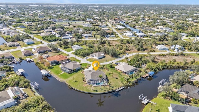 birds eye view of property with a water view and a residential view