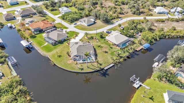 birds eye view of property featuring a water view and a residential view