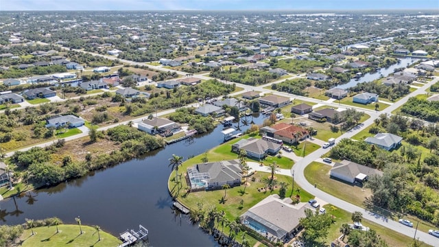 drone / aerial view with a residential view and a water view