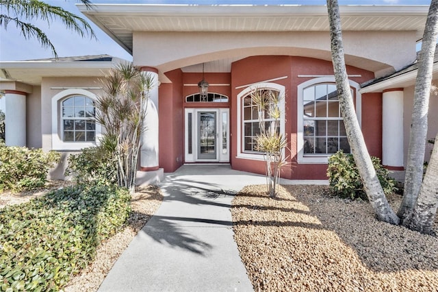 property entrance featuring stucco siding