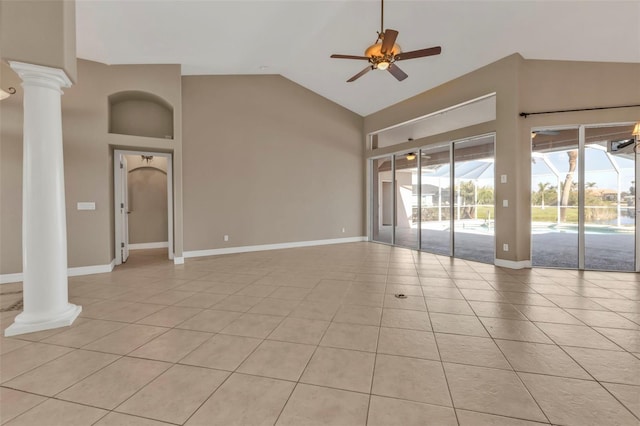 unfurnished living room featuring light tile patterned flooring, ceiling fan, high vaulted ceiling, decorative columns, and baseboards