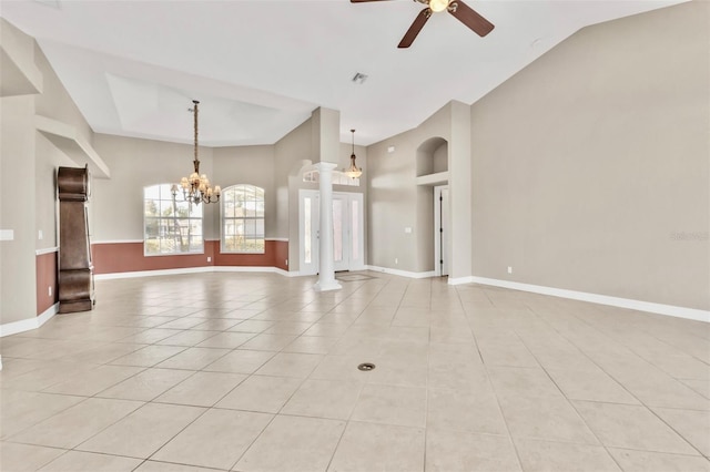 unfurnished living room with light tile patterned floors, baseboards, high vaulted ceiling, and ceiling fan with notable chandelier