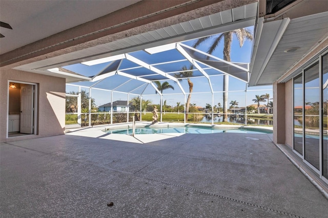 pool with a lanai and a patio area