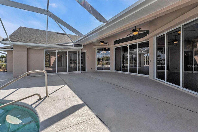 exterior space with a patio, ceiling fan, a shingled roof, and stucco siding