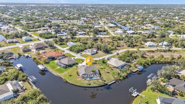 drone / aerial view featuring a residential view and a water view