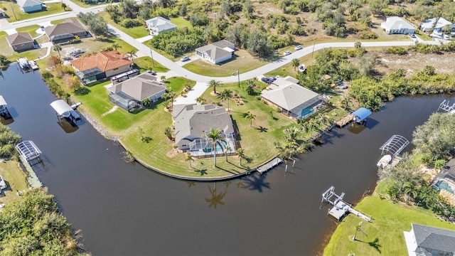 birds eye view of property with a water view and a residential view