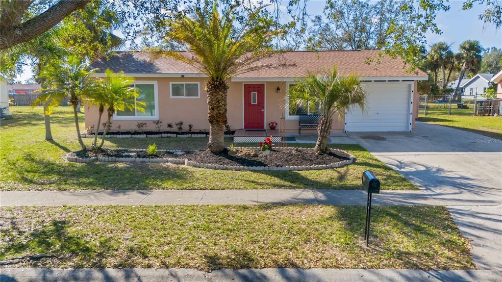 single story home featuring a garage and a front yard