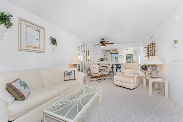 carpeted living room with ceiling fan