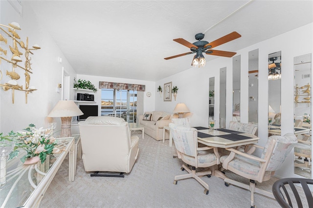 living room featuring ceiling fan and light colored carpet