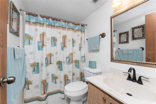 bathroom featuring vanity, toilet, and curtained shower