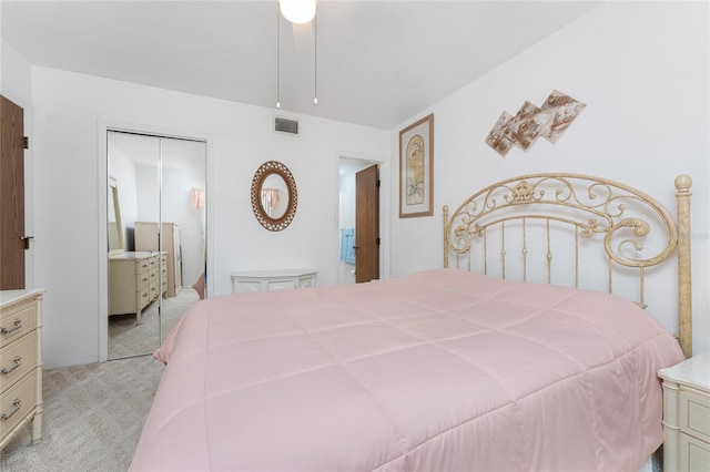 bedroom with light carpet and a closet