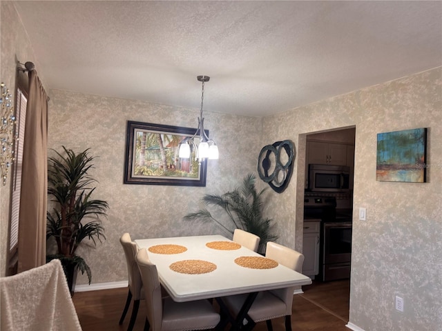 dining space featuring dark hardwood / wood-style flooring and a textured ceiling