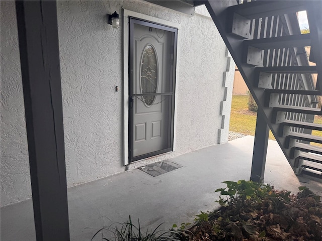 entrance to property featuring stucco siding