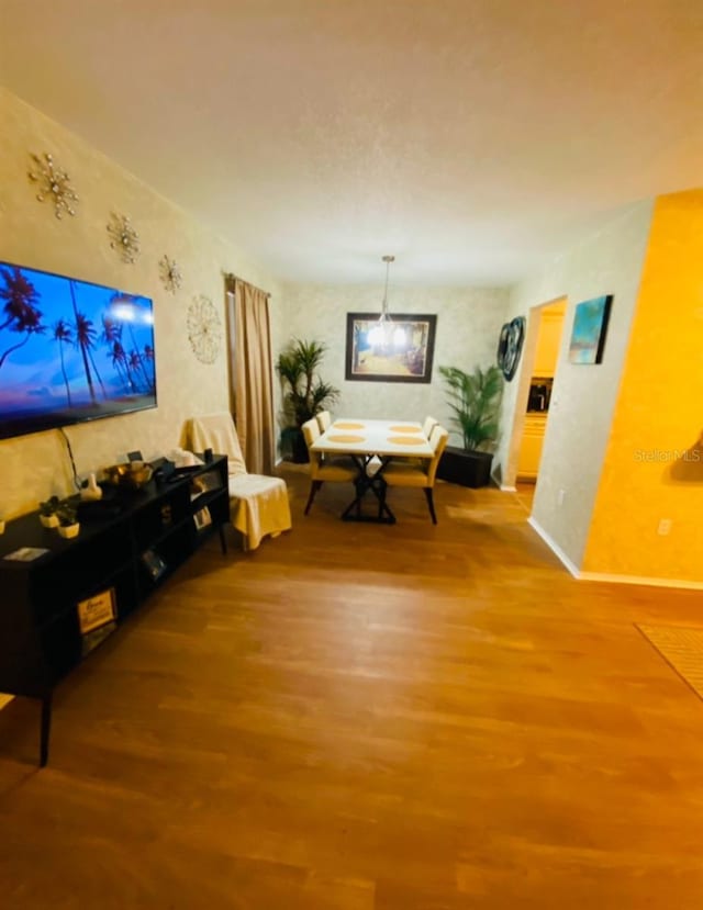 living room featuring hardwood / wood-style flooring and a chandelier