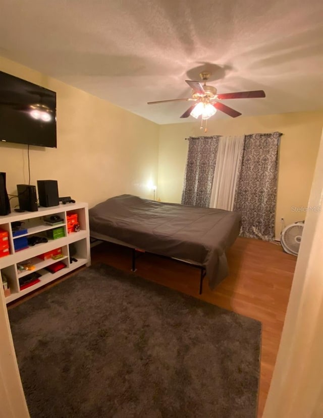 bedroom with ceiling fan and hardwood / wood-style floors