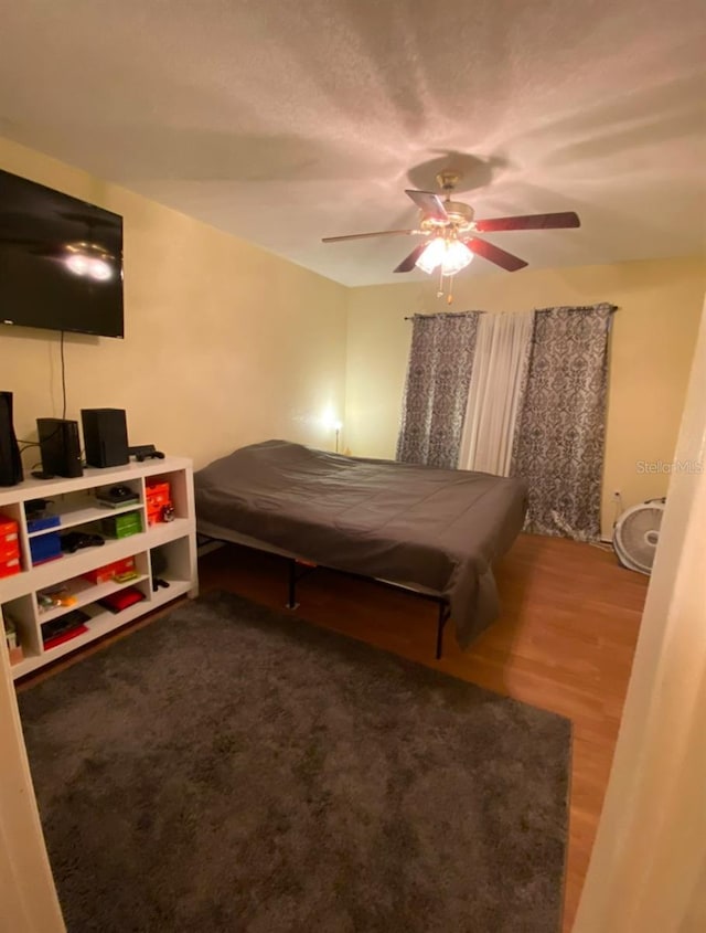 bedroom with ceiling fan and wood-type flooring