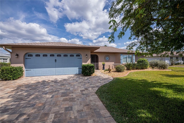 single story home with a garage and a front lawn