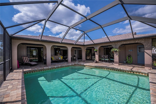 view of pool with a patio and glass enclosure