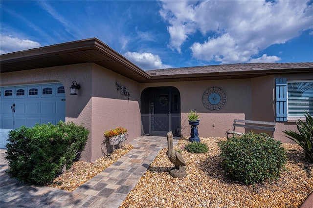 view of exterior entry featuring a garage