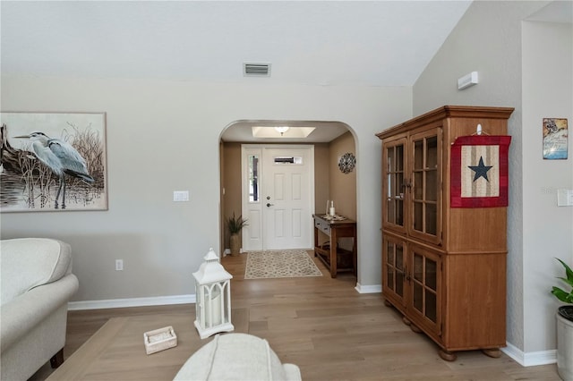 entrance foyer with light hardwood / wood-style flooring and vaulted ceiling