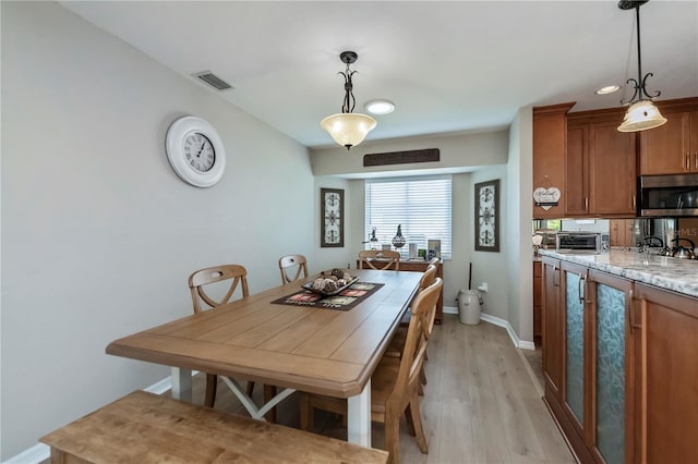 dining space with light hardwood / wood-style floors