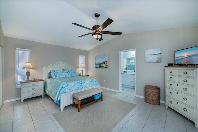 tiled bedroom with lofted ceiling, connected bathroom, and ceiling fan