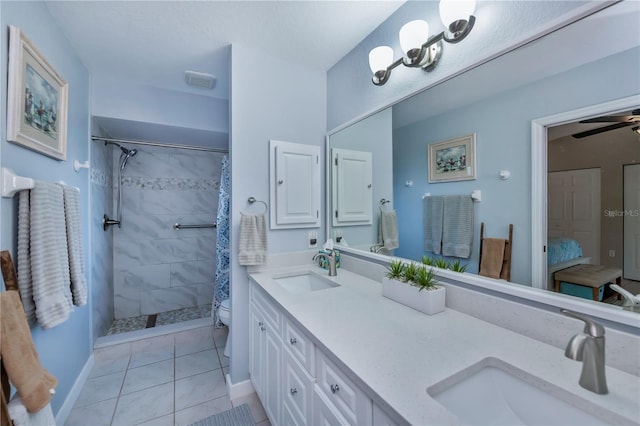 bathroom featuring toilet, a shower with curtain, vanity, ceiling fan, and tile patterned flooring