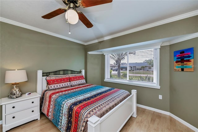 bedroom with crown molding, ceiling fan, and light hardwood / wood-style flooring