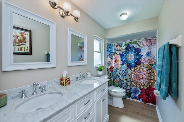 bathroom with vanity, toilet, curtained shower, and hardwood / wood-style floors