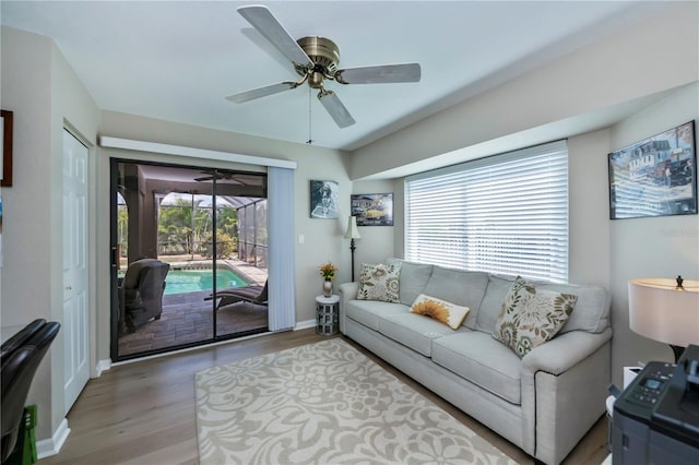 living room featuring hardwood / wood-style flooring and ceiling fan