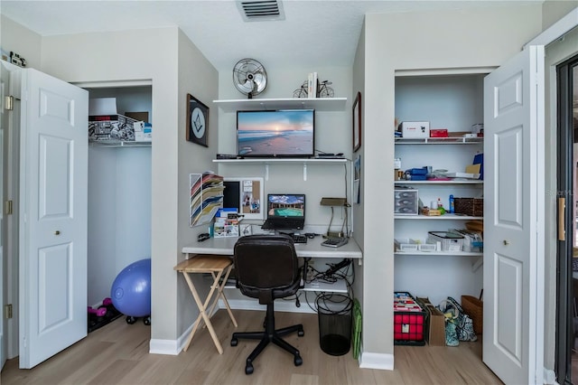 office space with light hardwood / wood-style floors