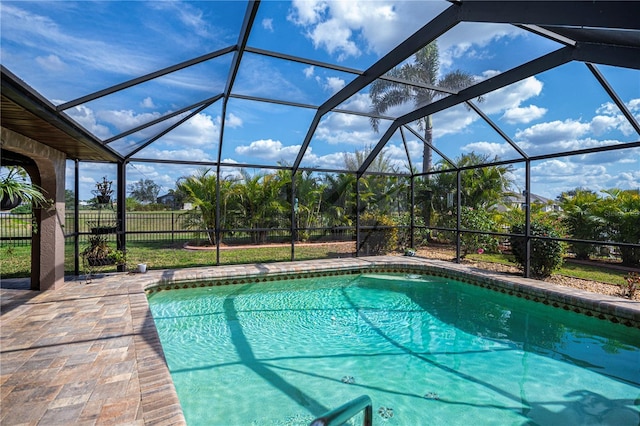 view of swimming pool with a lanai and a patio area