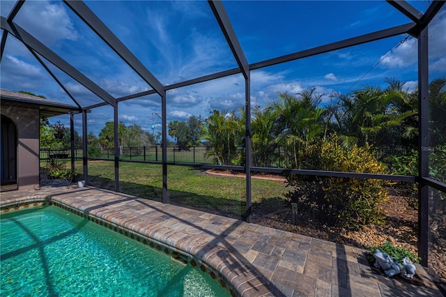 view of pool with a yard, a lanai, and a patio area