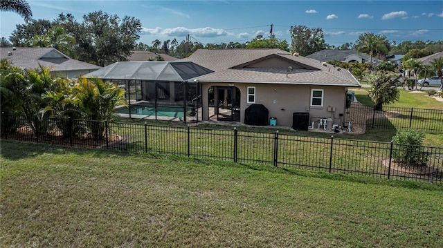 back of house featuring a fenced in pool, a lanai, a yard, central AC unit, and a patio area