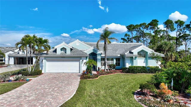 view of front of property featuring a garage and a front yard