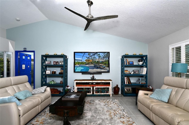 tiled living room with lofted ceiling, a textured ceiling, and ceiling fan