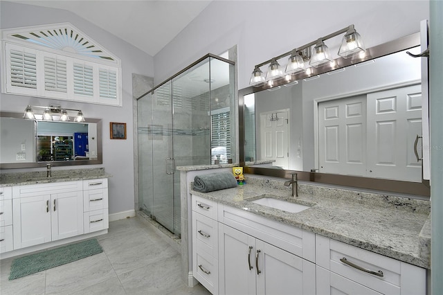 bathroom with a shower with door, vaulted ceiling, and vanity