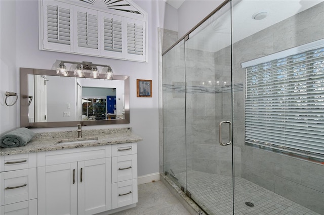 bathroom with vanity and a shower with shower door