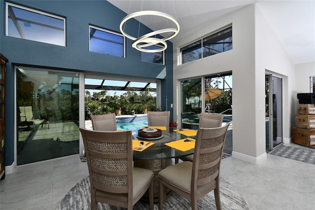 dining space with high vaulted ceiling and a notable chandelier