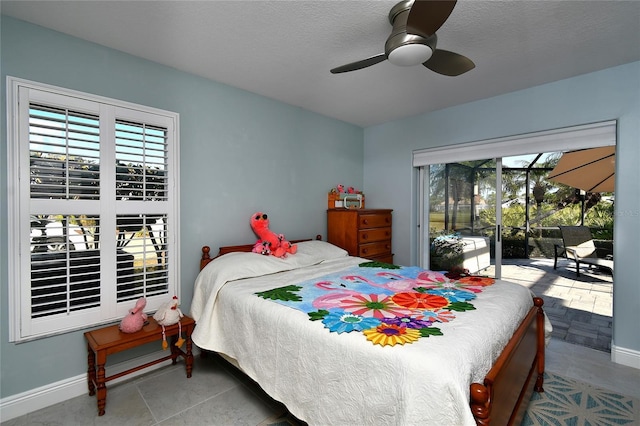 bedroom with ceiling fan, access to exterior, and a textured ceiling