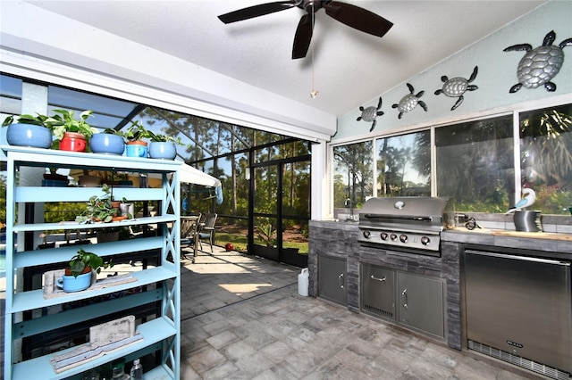 sunroom featuring ceiling fan and lofted ceiling