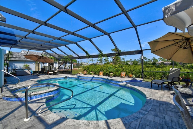 view of pool featuring an in ground hot tub, a lanai, and a patio area