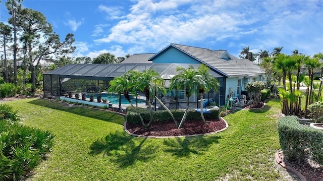 view of swimming pool with a yard and a lanai